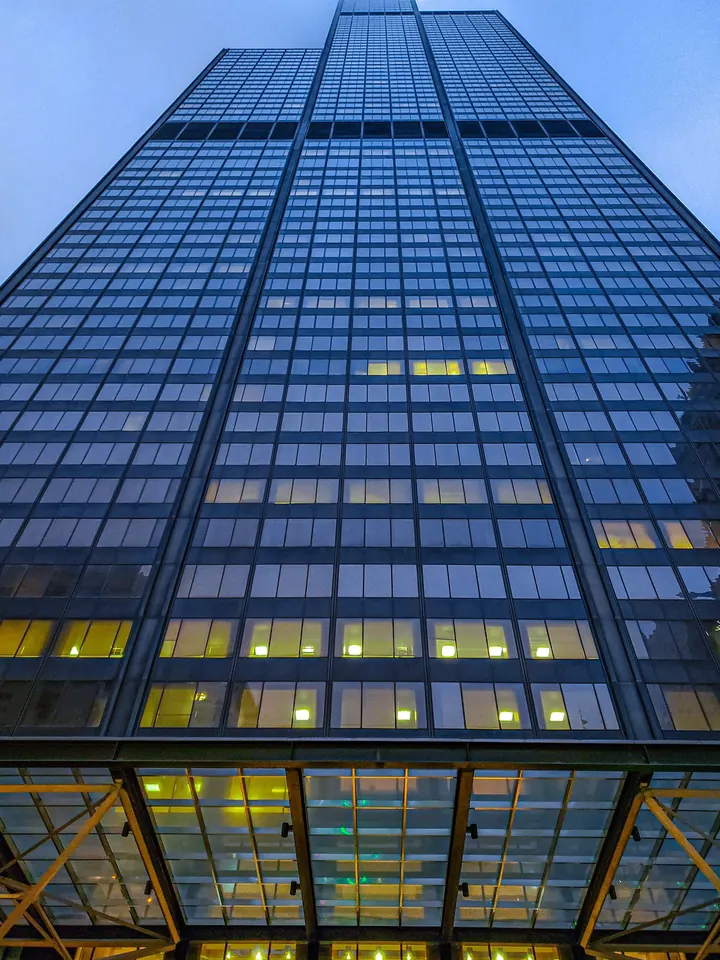 Looking straight up the glass face of Willis Tower at dusk